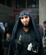 A widely circulated image of an Al-Nusra fighter in Northern Syria. A highly sophisticated chemical riot control grenade can be seen, indicating outside state-sponsorship. This image and others, was the focus of a number of Syria weapons watch websites speculating whether or not the rebels had chemical weapons capabilities.